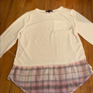 A white long sleeve shirt with a design at bottom